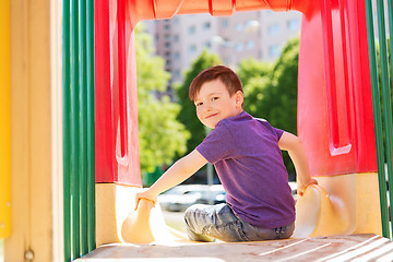 Image showing happy little boy on slide at children playground