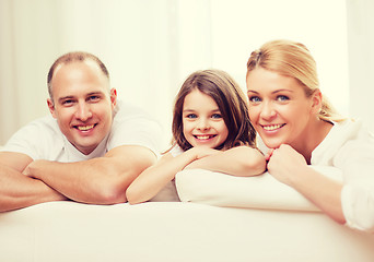 Image showing smiling parents and little girl at home