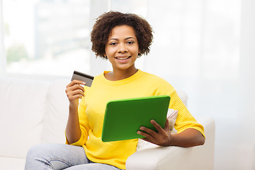 Image showing happy african woman with tablet pc and credit card