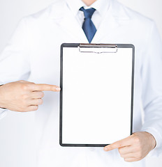 Image showing doctor pointing at blank white paper