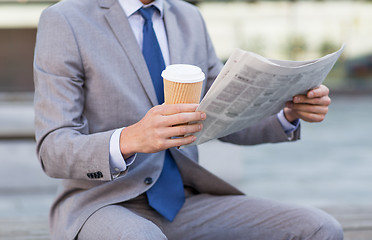 Image showing close up of businessman reading newspaper