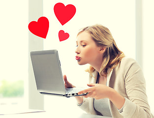 Image showing woman sending kisses with laptop computer