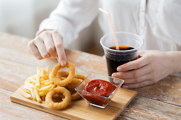 Image showing close up of woman with snacks and cocacola