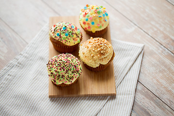 Image showing close up of glazed cupcakes or muffins on table