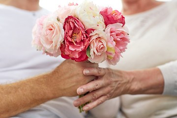 Image showing close up of senior couple with flowers 