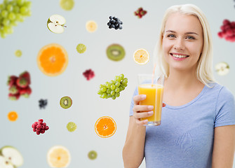 Image showing smiling woman drinking orange juice at home