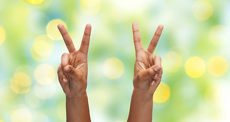 Image showing two african hands showing victory or peace sign