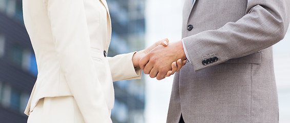 Image showing close up of business couple shaking hands