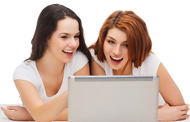 Image showing two smiling teenage girsl with laptop computer