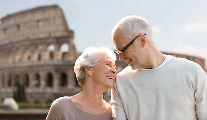 Image showing happy senior couple over coliseum in rome, italy