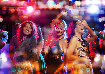 Image showing happy friends dancing in club with holidays lights