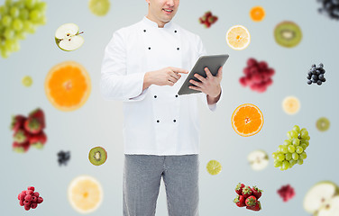 Image showing close up of happy male chef cook holding tablet pc