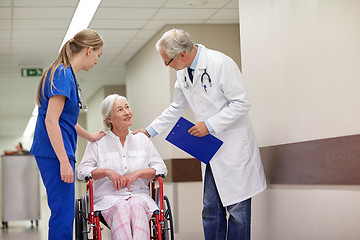 Image showing medics and senior woman in wheelchair at hospital