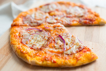 Image showing close up of homemade pizza on wooden table