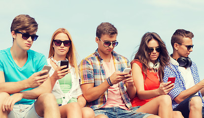 Image showing group of friends with smartphones outdoors