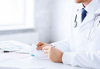 Image showing male doctor writing prescription paper