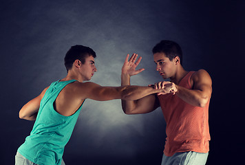 Image showing young men wrestling