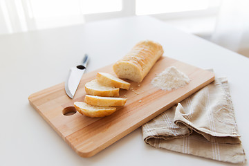 Image showing close up of white bread or baguette and knife