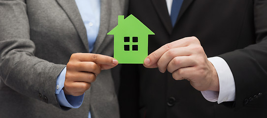 Image showing businessman and businesswoman holding green house