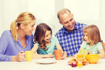 Image showing happy family with two kids with having breakfast