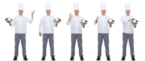 Image showing happy male chef cook holding cloche