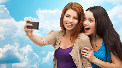 Image showing happy teenage girls taking selfie with smartphone