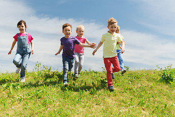 Image showing group of happy kids running outdoors