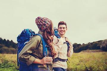 Image showing smiling couple with backpacks hiking