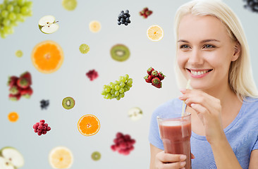 Image showing smiling woman drinking juice or shake at home