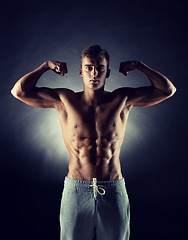 Image showing young man showing biceps