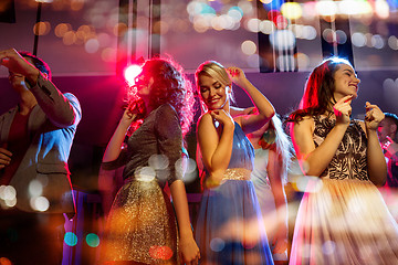 Image showing happy friends dancing in club with holidays lights