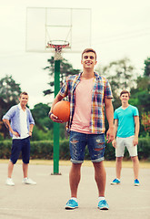 Image showing group of smiling teenagers playing basketball