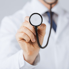 Image showing doctor hand with stethoscope listening something