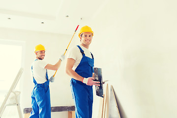 Image showing group of builders with tools indoors