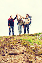 Image showing group of smiling friends with backpacks hiking