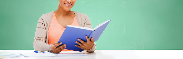 Image showing afro american student girl reading book at school