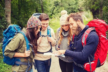 Image showing group of smiling friends with backpacks hiking