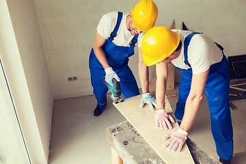 Image showing group of builders with tools indoors