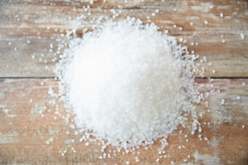 Image showing close up of white salt heap on wooden table