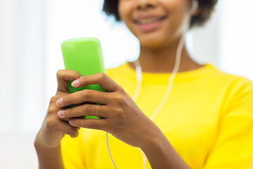 Image showing happy african woman with smartphone and headphones