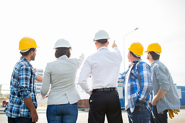 Image showing group of builders and architects at building site