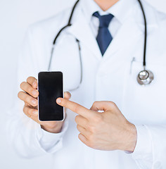 Image showing doctor pointing at smartphone