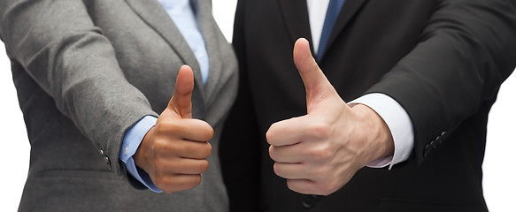 Image showing businessman and businesswoman showing thumbs up