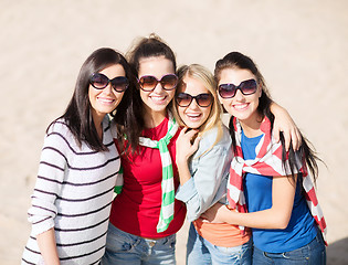 Image showing happy teenage girls or young women on beach