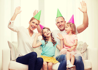 Image showing happy family with two kids in hats celebrating