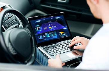 Image showing man using navigation on laptop computer in car