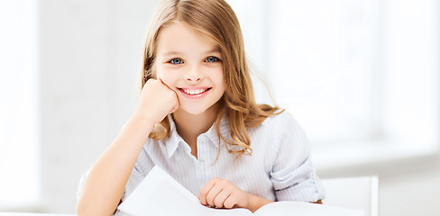 Image showing little student girl studying at school