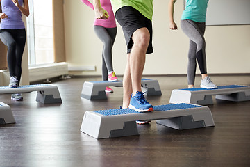 Image showing group of people flexing legs on step platforms