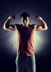 Image showing young man showing biceps