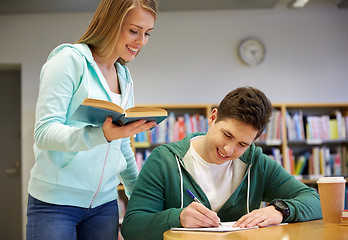 Image showing happy students preparing to exams in library